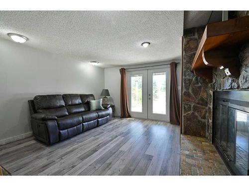 24027 Highway 595, Rural Red Deer County, AB - Indoor Photo Showing Living Room With Fireplace