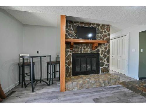 24027 Highway 595, Rural Red Deer County, AB - Indoor Photo Showing Living Room With Fireplace