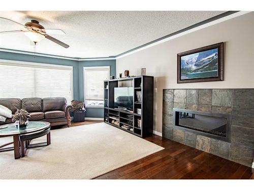 30 Country, Clive, AB - Indoor Photo Showing Living Room With Fireplace