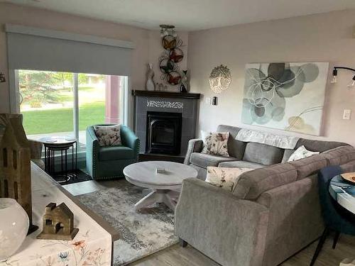 113-18 Averill Street, Red Deer, AB - Indoor Photo Showing Living Room With Fireplace