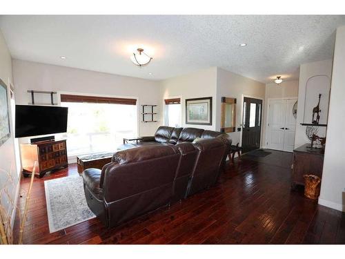 32015 292 Avenue East, De Winton, AB - Indoor Photo Showing Living Room With Fireplace