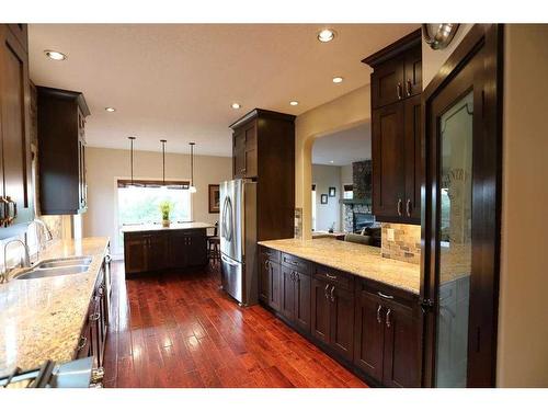 32015 292 Avenue East, De Winton, AB - Indoor Photo Showing Kitchen With Stainless Steel Kitchen With Double Sink