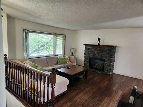 511 Queen Alexandra Way Se, Calgary, AB - Indoor Photo Showing Living Room With Fireplace