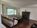 511 Queen Alexandra Way Se, Calgary, AB  - Indoor Photo Showing Living Room With Fireplace 