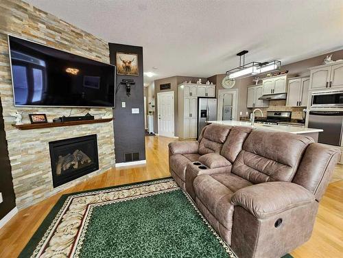 103-1600 Main Street Sw, Slave Lake, AB - Indoor Photo Showing Living Room With Fireplace