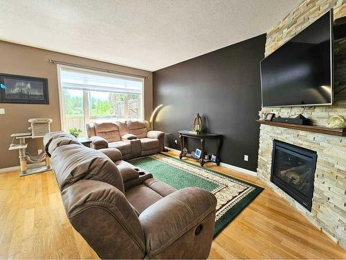 103-1600 Main Street Sw, Slave Lake, AB - Indoor Photo Showing Living Room With Fireplace