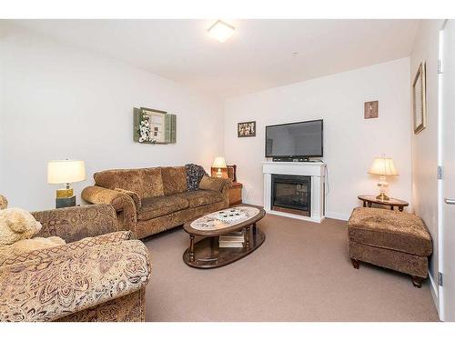 5112-2660 22 Street, Red Deer, AB - Indoor Photo Showing Living Room With Fireplace