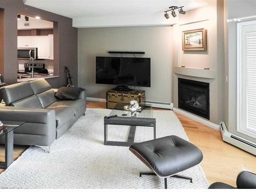 126-5300 48 Street, Red Deer, AB - Indoor Photo Showing Living Room With Fireplace
