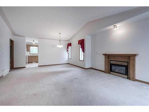 11 Westin Place, Sylvan Lake, AB - Indoor Photo Showing Living Room With Fireplace