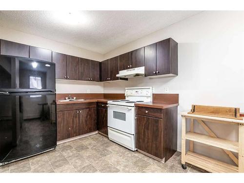 101-304-6821 59 Avenue, Red Deer, AB - Indoor Photo Showing Kitchen With Double Sink