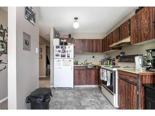 101-304-6821 59 Avenue, Red Deer, AB - Indoor Photo Showing Kitchen With Double Sink