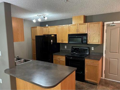 122-18 Averill Street, Red Deer, AB - Indoor Photo Showing Kitchen With Double Sink
