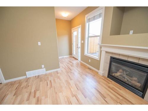 38-45 Ironstone Drive, Red Deer, AB - Indoor Photo Showing Living Room With Fireplace