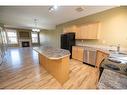 38-45 Ironstone Drive, Red Deer, AB  - Indoor Photo Showing Kitchen With Fireplace With Double Sink 