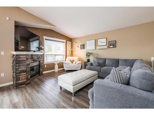 23 Lodge Place, Sylvan Lake, AB - Indoor Photo Showing Living Room With Fireplace