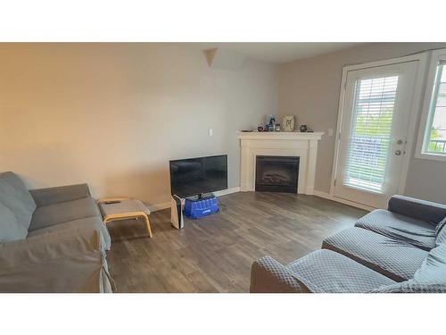 303-3730 50 Avenue, Red Deer, AB - Indoor Photo Showing Living Room With Fireplace