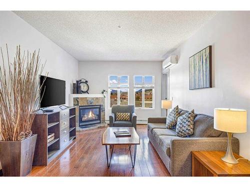 313-1151 Sidney Street, Canmore, AB - Indoor Photo Showing Living Room With Fireplace