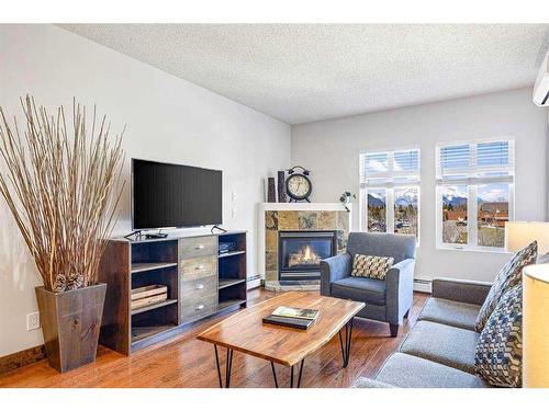 313-1151 Sidney Street, Canmore, AB - Indoor Photo Showing Living Room With Fireplace