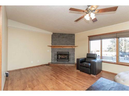 234-28302 Highway 12A, Rural Lacombe County, AB - Indoor Photo Showing Living Room With Fireplace