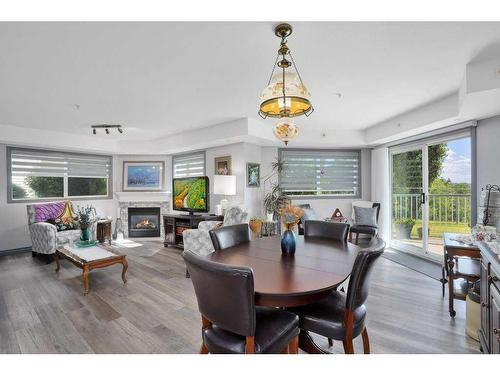 L01-6118 53 Avenue, Red Deer, AB - Indoor Photo Showing Dining Room With Fireplace