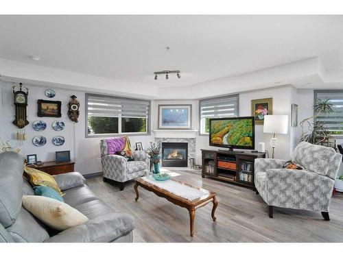 L01-6118 53 Avenue, Red Deer, AB - Indoor Photo Showing Living Room With Fireplace