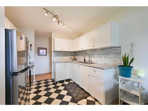 101-4814 46 Street, Red Deer, AB - Indoor Photo Showing Kitchen With Double Sink