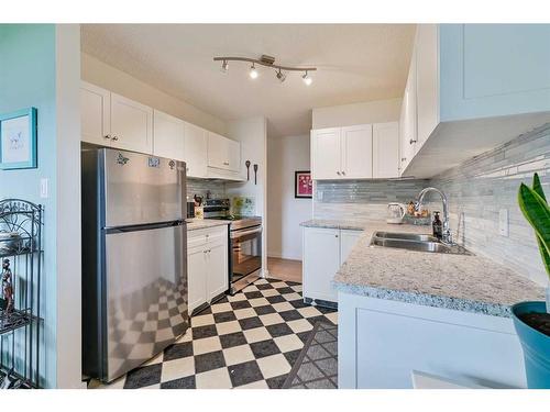 101-4814 46 Street, Red Deer, AB - Indoor Photo Showing Kitchen With Double Sink