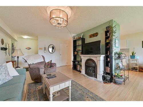 101-4814 46 Street, Red Deer, AB - Indoor Photo Showing Living Room With Fireplace