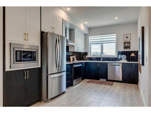 303-8235 8 Avenue Sw, Calgary, AB - Indoor Photo Showing Kitchen With Upgraded Kitchen