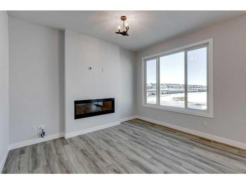 342 Sora Way Se, Calgary, AB - Indoor Photo Showing Living Room With Fireplace