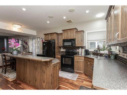 110-150 Vanier Drive, Red Deer, AB - Indoor Photo Showing Kitchen With Double Sink