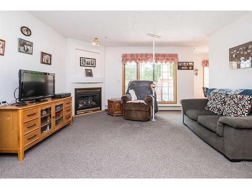 130-4805 45 Street, Red Deer, AB - Indoor Photo Showing Living Room With Fireplace