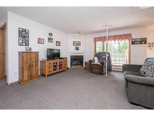 130-4805 45 Street, Red Deer, AB - Indoor Photo Showing Living Room With Fireplace