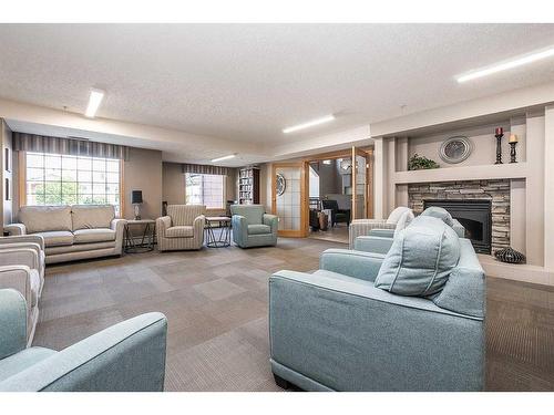 130-4805 45 Street, Red Deer, AB - Indoor Photo Showing Living Room With Fireplace