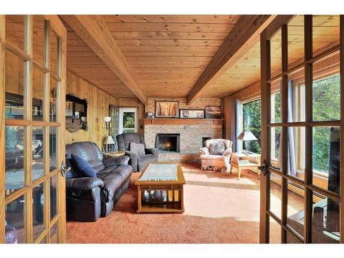 201, 35276 Range Road 10, Rural Red Deer County, AB - Indoor Photo Showing Living Room With Fireplace