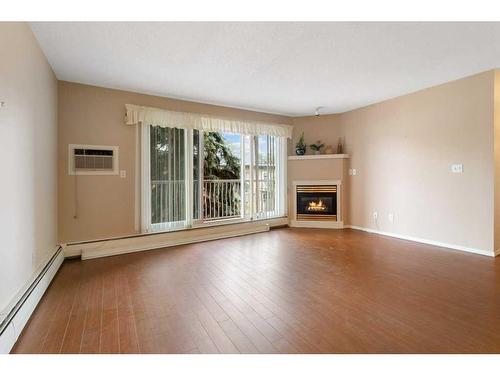 302-5326 47 Avenue, Red Deer, AB - Indoor Photo Showing Living Room With Fireplace