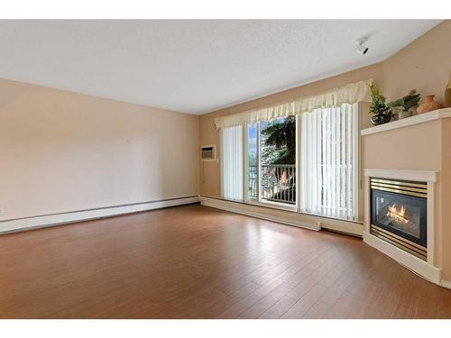 302-5326 47 Avenue, Red Deer, AB - Indoor Photo Showing Living Room With Fireplace