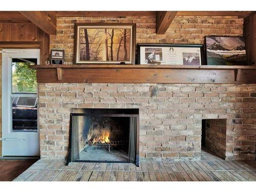 201, 35276 Range Road 10, Rural Red Deer County, AB - Indoor Photo Showing Living Room With Fireplace