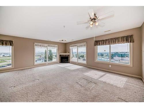 411-4425 Heritage Way, Lacombe, AB - Indoor Photo Showing Living Room With Fireplace