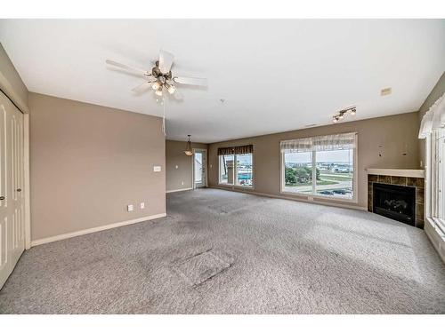 411-4425 Heritage Way, Lacombe, AB - Indoor With Fireplace