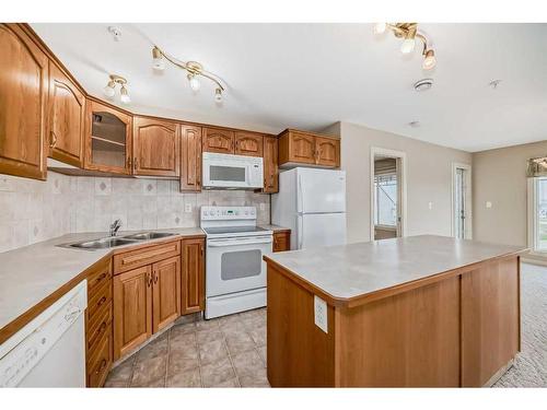 411-4425 Heritage Way, Lacombe, AB - Indoor Photo Showing Kitchen With Double Sink