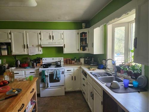 7501 C And E Trail, Innisfail, AB - Indoor Photo Showing Kitchen With Double Sink