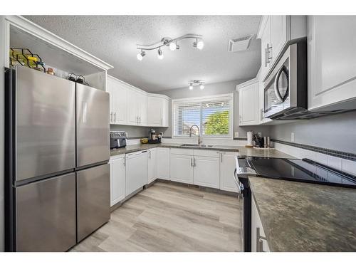 140 Vickers Close, Red Deer, AB - Indoor Photo Showing Kitchen With Stainless Steel Kitchen With Double Sink