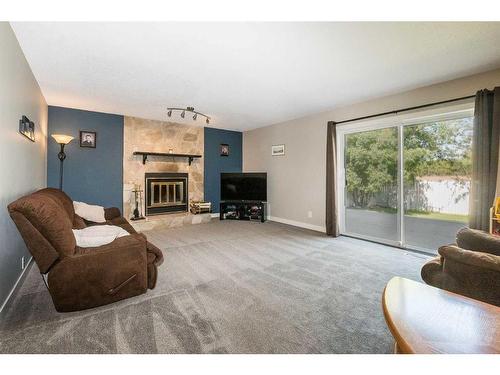 85 Rutledge Crescent, Red Deer, AB - Indoor Photo Showing Living Room With Fireplace