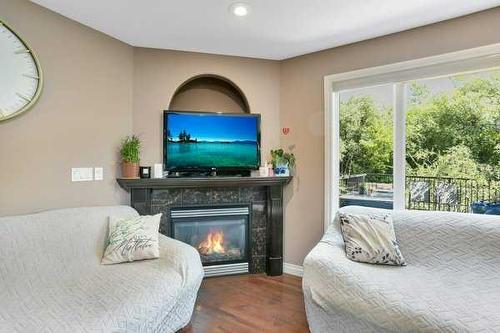 16 Oakwood Close, Red Deer, AB - Indoor Photo Showing Bedroom With Fireplace