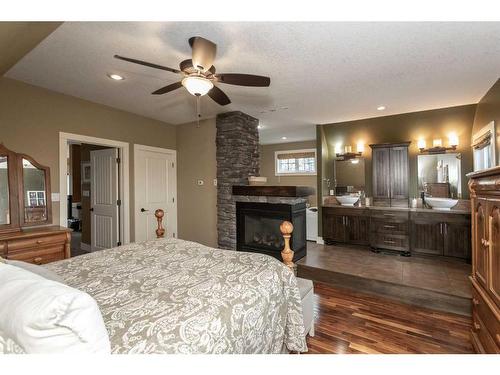 431 Summer Crescent, Rural Ponoka County, AB - Indoor Photo Showing Bedroom With Fireplace