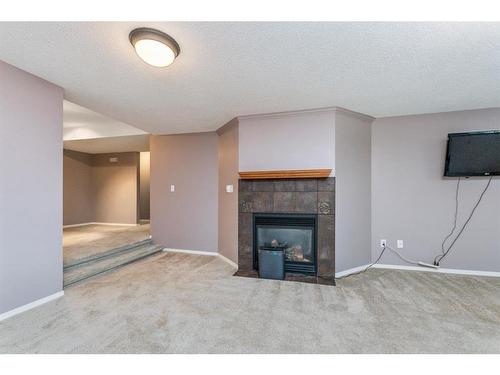 115-28342 Township Road, Rural Red Deer County, AB - Indoor Photo Showing Living Room With Fireplace