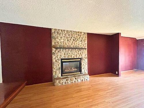 5009 57 Street, Stettler, AB - Indoor Photo Showing Living Room With Fireplace