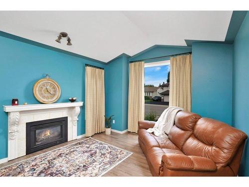 71 Anquetel Street, Red Deer, AB - Indoor Photo Showing Living Room With Fireplace