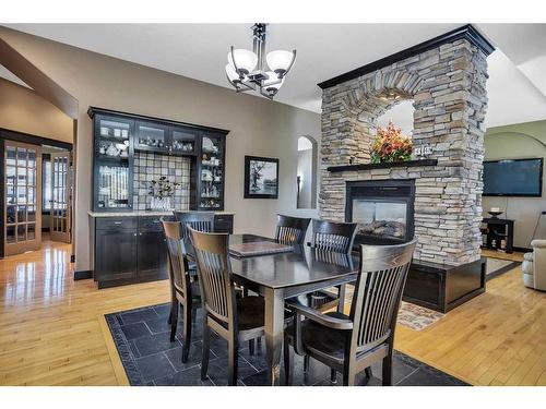 4 Fieldstone Way, Sylvan Lake, AB - Indoor Photo Showing Dining Room With Fireplace